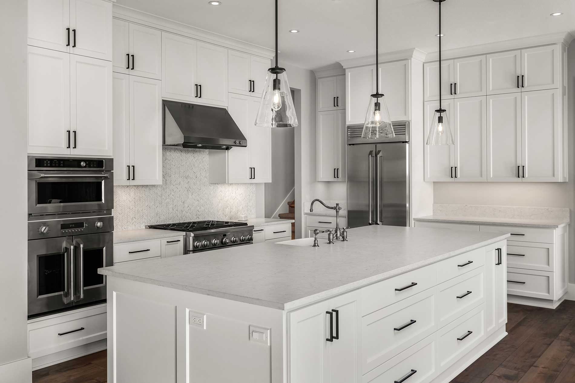 modern white kitchen with ceiling hanging lights